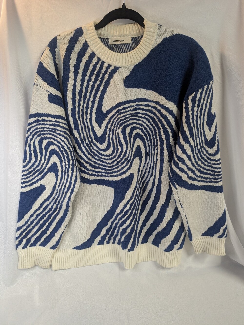 Aelfric Eden Whirlpool Knit Sweater in blue and white, featuring an abstract opt